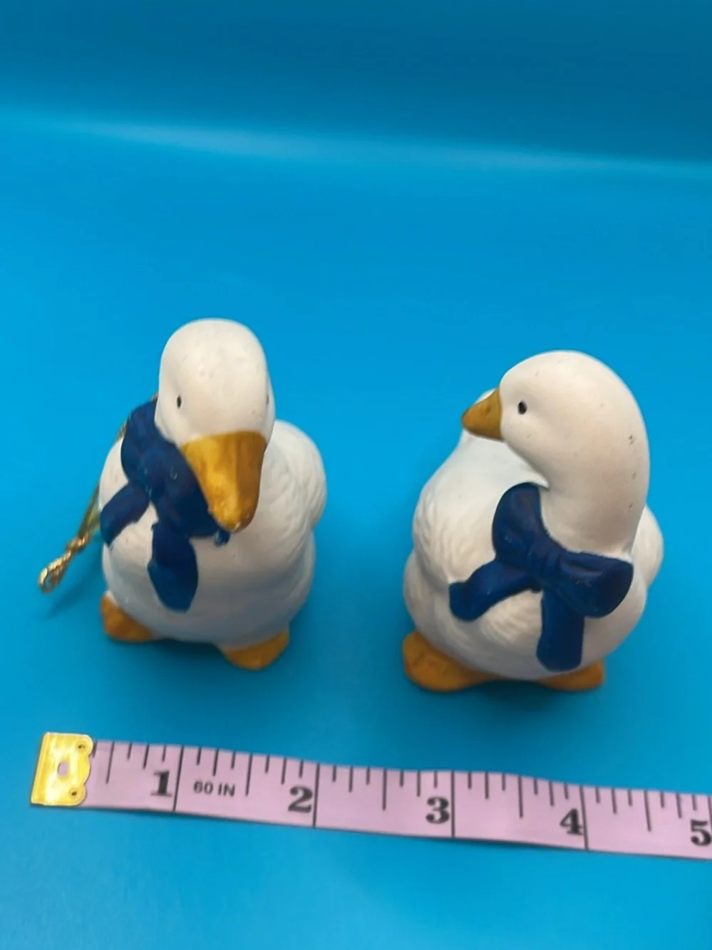 Pair of White Porcelain Duck Figurines with Blue Bows